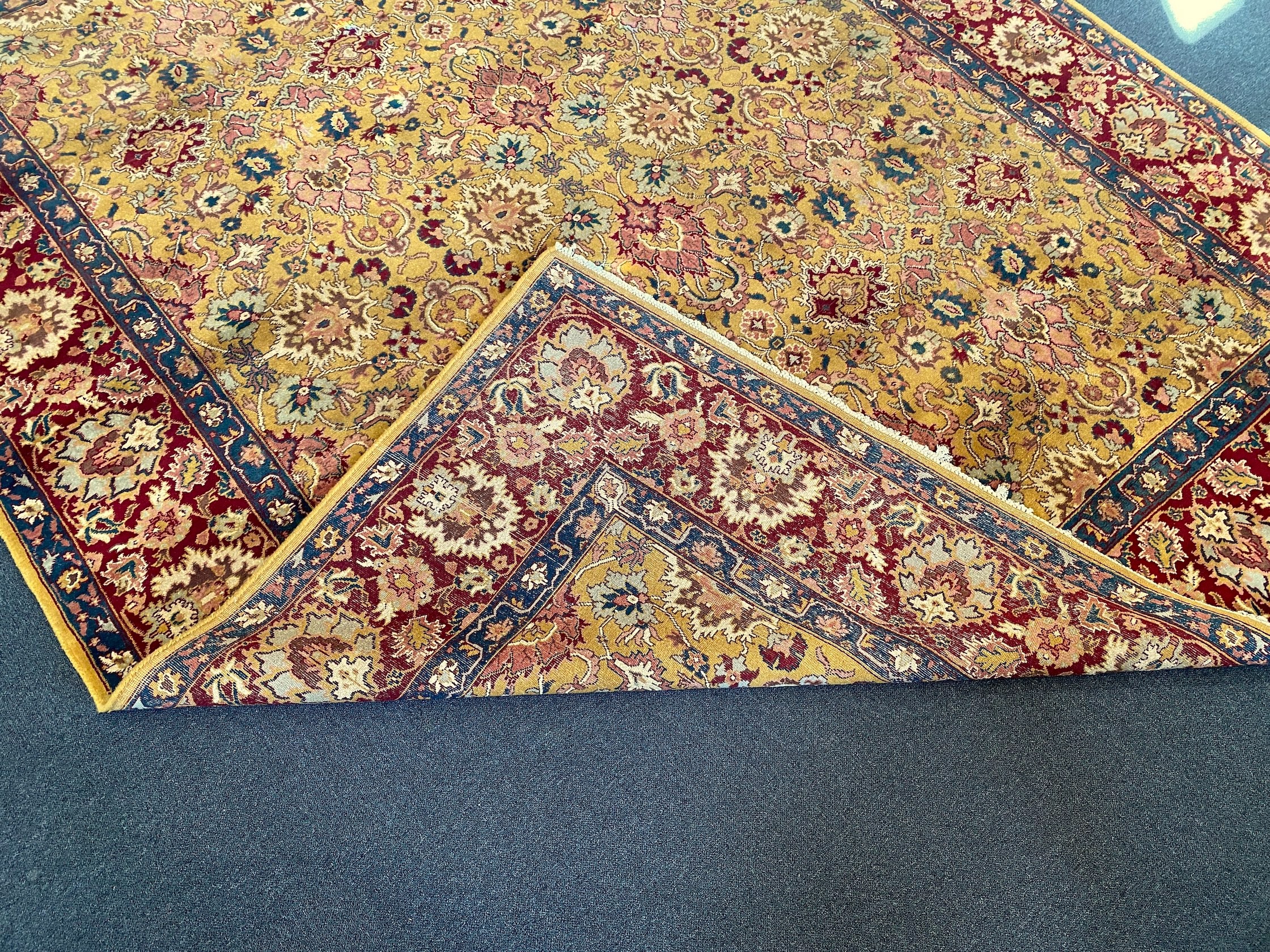 An Agra gold ground carpet with dense palmette field and wide conforming border 360 x 280 cms